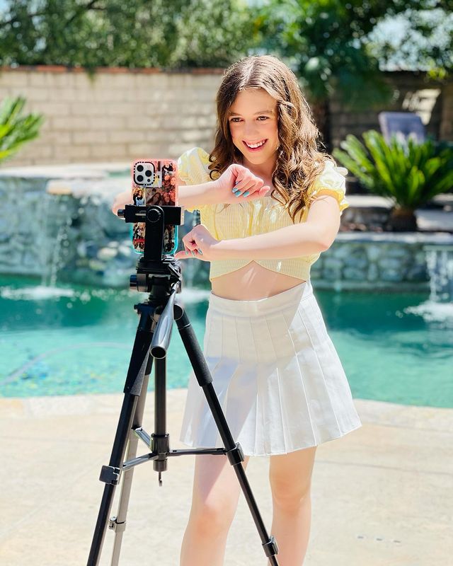She is wearing yellow top-shirt and white-skirt.