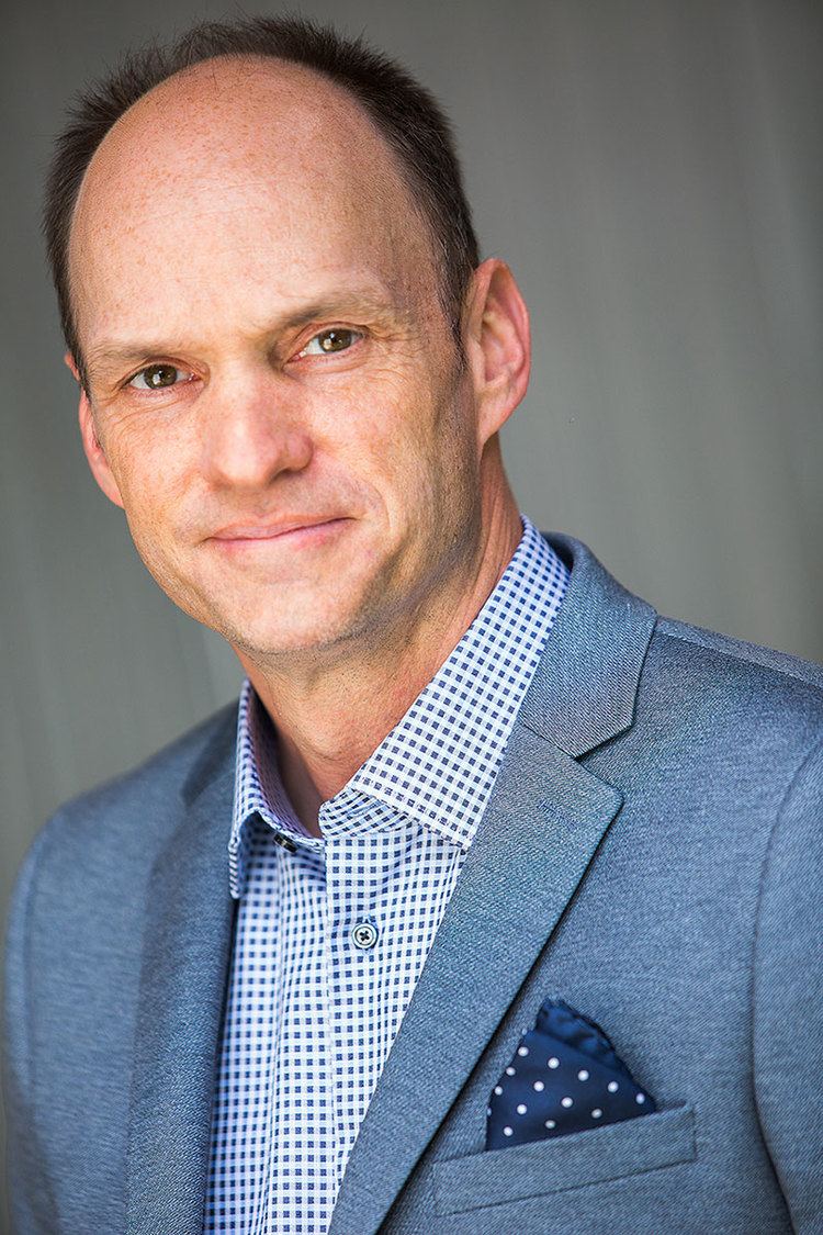 Brian Stepanek wearing coat and shirt