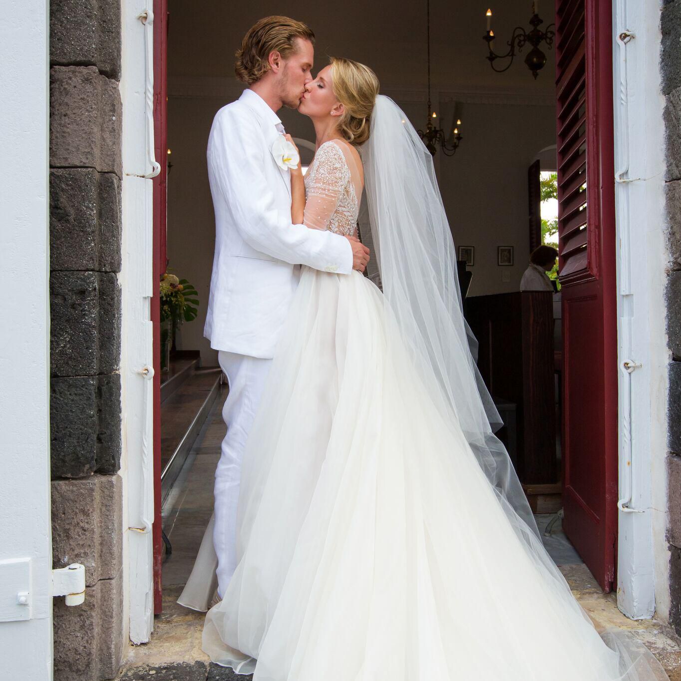 Tessa was wearing white gown and her husband was wearing White coat and pants.