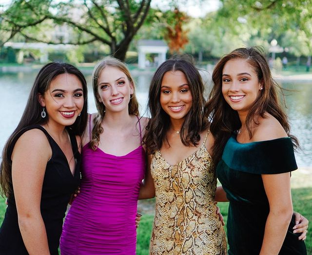 Corinne Massiah and her all three friends are wearing one-piece in different colors such as green, pink, black and yellow designed with roots.