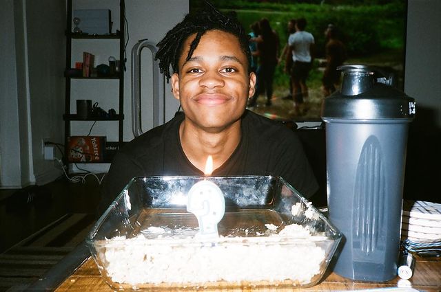 Tyrel wearing black t-shirt with birthday cake.