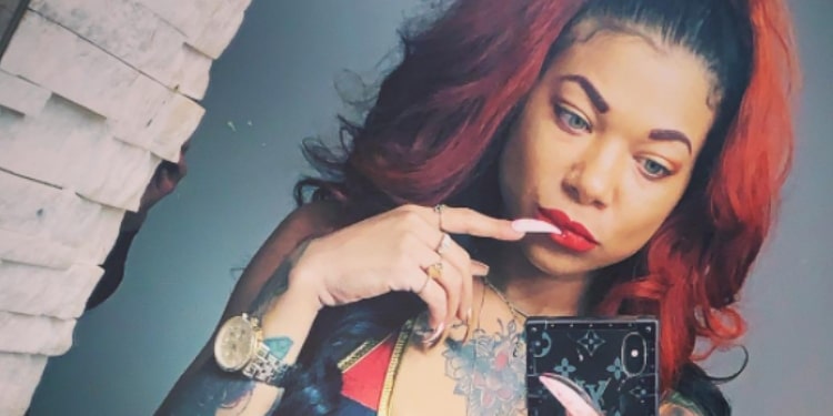 Dyana DeGrate posing for Photo with her index finger on her mouth