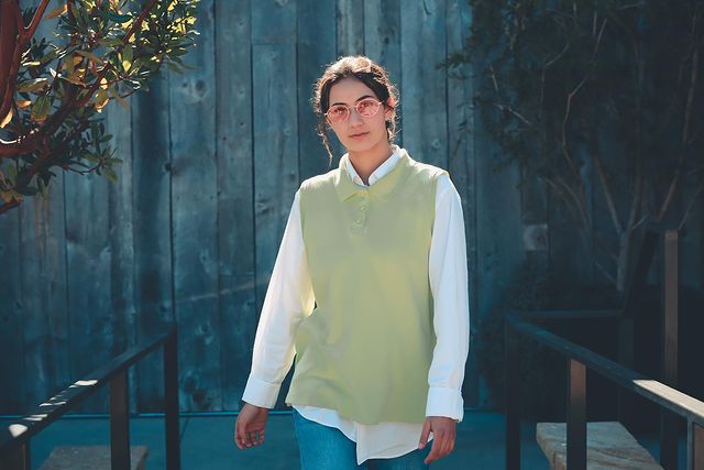 Lalania is wearing blue jeans pant and white shirt with light green half-sweater.