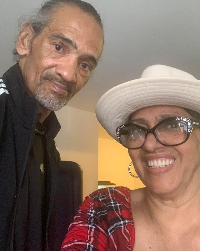 Bunny wearing a white hat and strip mix color t-shirt and Randy wearing black jacket.