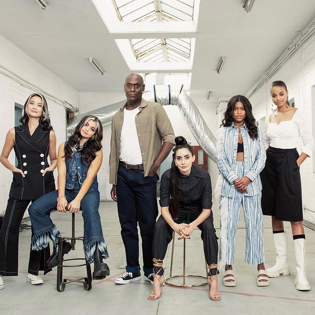 Ella wearing white and black skirt with white boot along with her crew member.