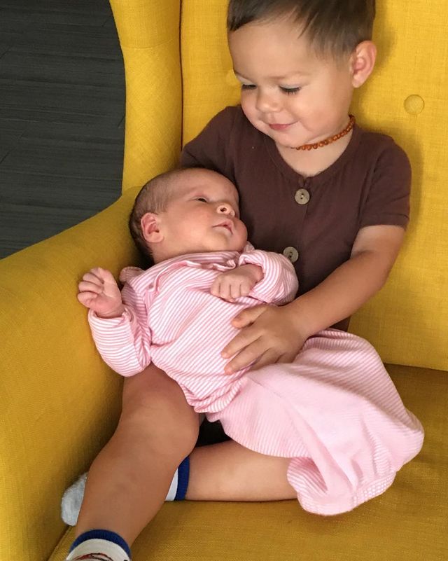 Older one holding smaller one and dress are pink and brown.