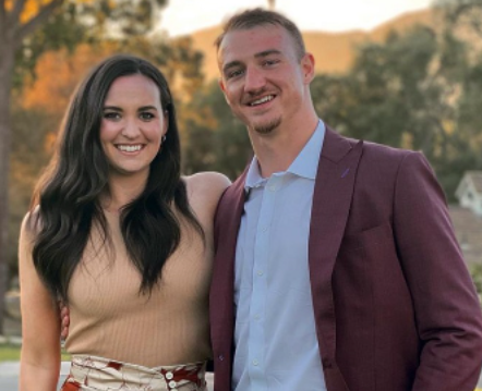 Sydney Golic with her husband Ben Braunecker posing for photo with a smile in the face 
