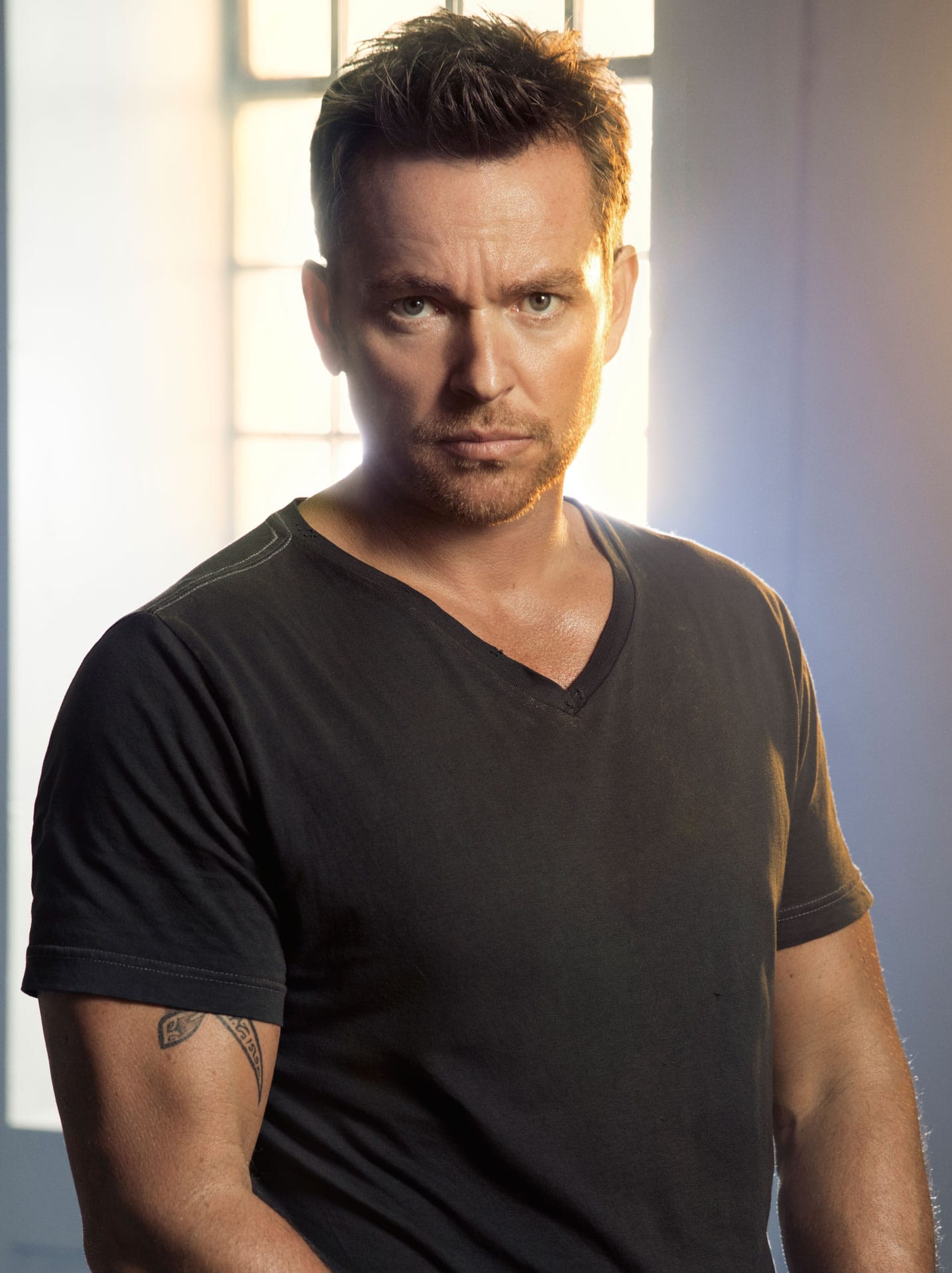 Jonathan Scarfe wearing black t-shirt with a short black hair.