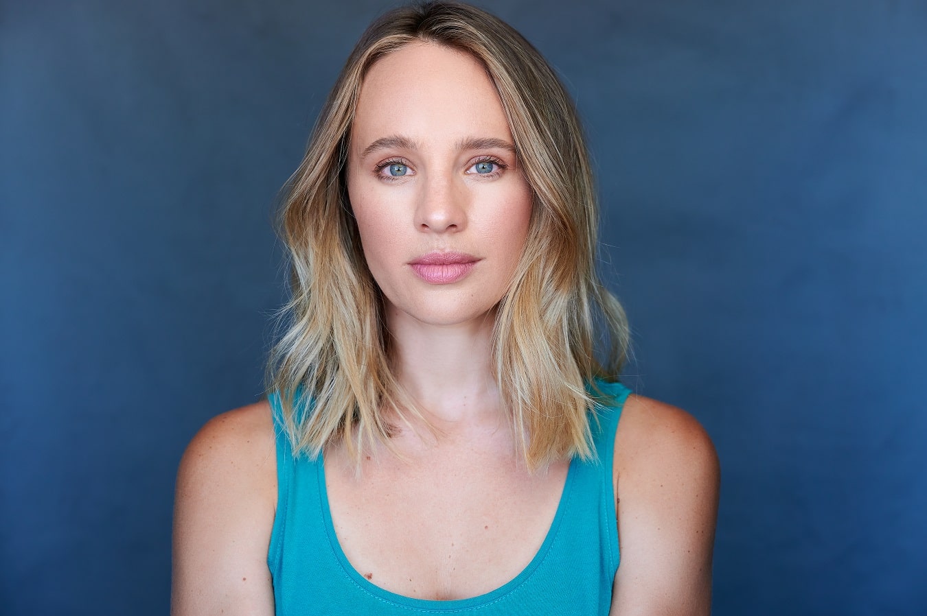 Natasha Loring in a short grey brown hair  wearing sky blue inner