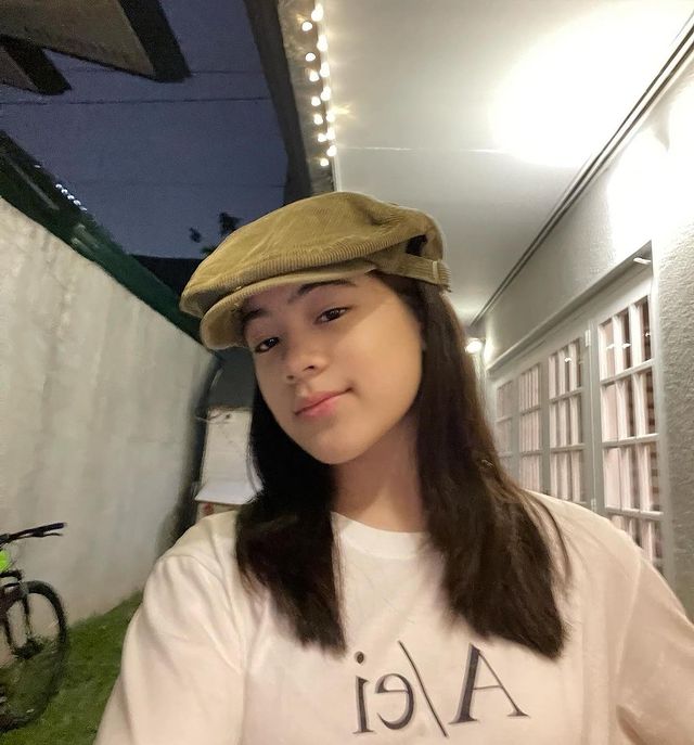 Niana Guerrero posing for the picture with making her hair in two sides and wearing whit t-shirt