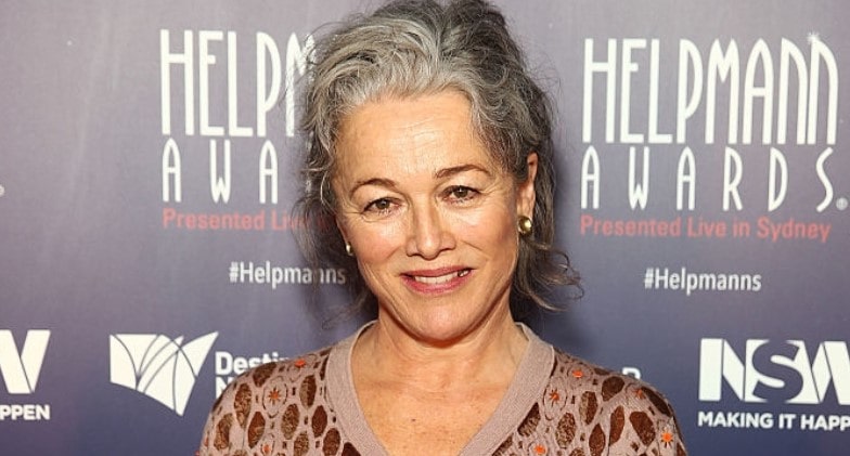 Sarah Peirse in a smiley face with a black and white short hair