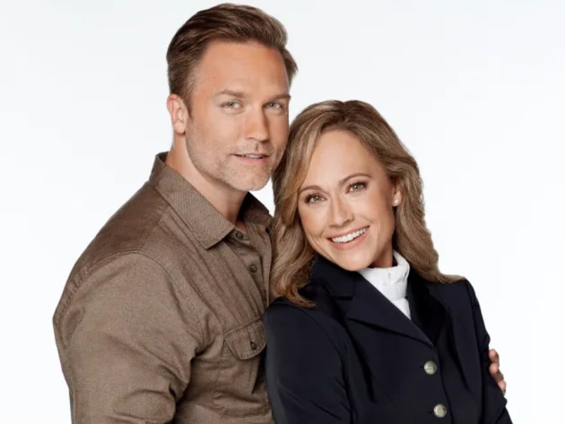 Nikki DeLoach posing for the picture with her husband Ryan Goodell with a smiley face 