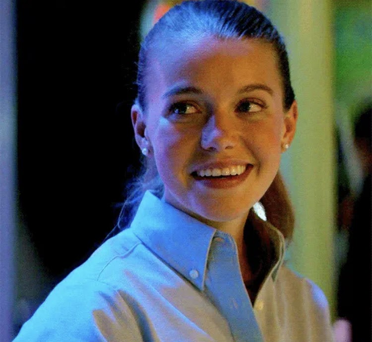 Devon Hales was captured looking at the right side wearing  and short brown hair and a smiley face