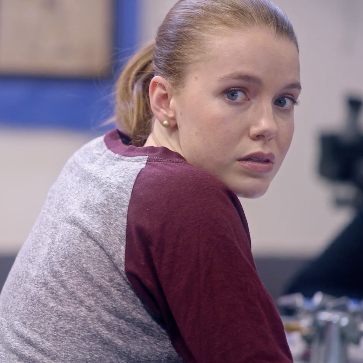 Devon Hales was captured looking at the right side with a serious look and wearing black and grey tshirt