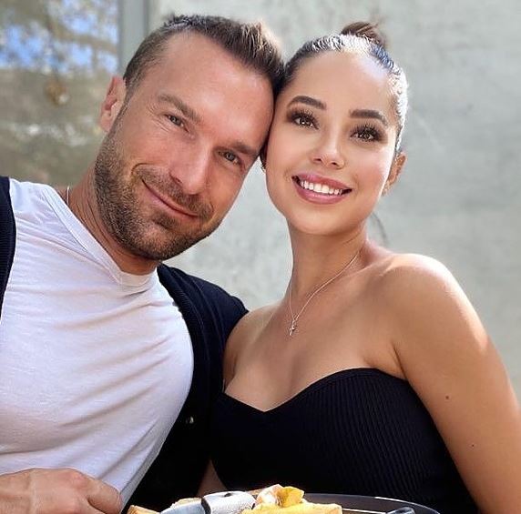 Picture of Marisol with her husband Bastian Yotta posing for a photoshoot wearing white and black dress