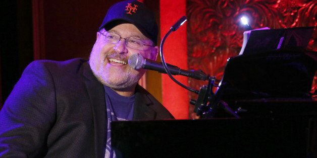 Frank Wildhorn was captured in a smiley face wearing black cap and black court