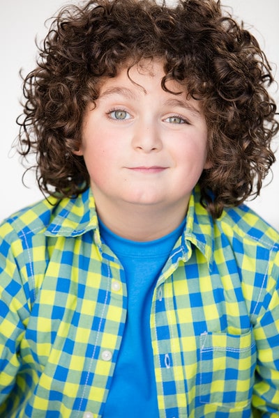 Picture of Elie Samuohi with a cute smile by wearing blue T-shirt.