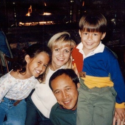 Childhood picture of Kaylee Hartung with her family posing for a photoshoot wearing white dress