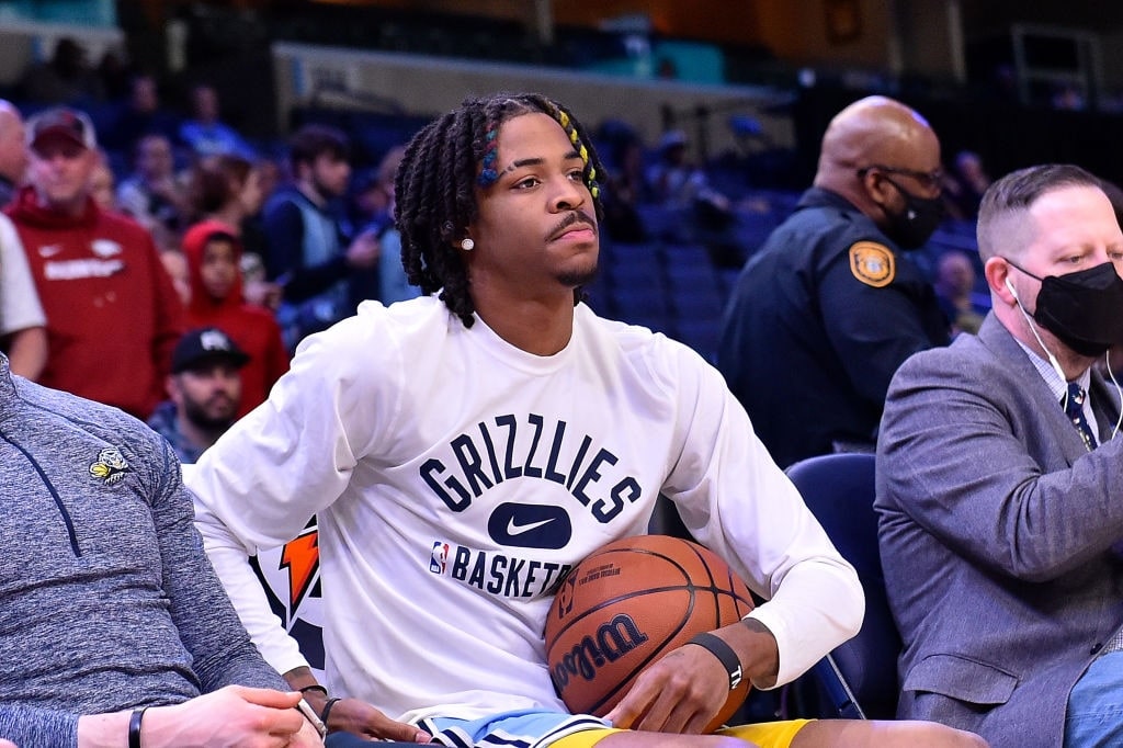 Picture Ja Morant with basketball by wearing white sweat shirt.