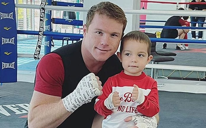 Picture of Saúl Adiel Alvarez with his father  Canelo Alvarez posing for a photos hoot wearing red color t shirt