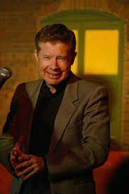 Lou Wagner was captured in the smiley face  wearing coat shirt and tie 