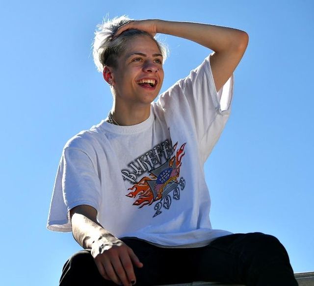Picture of Chris Daniels posing for a photoshoot wearing white color t shirt