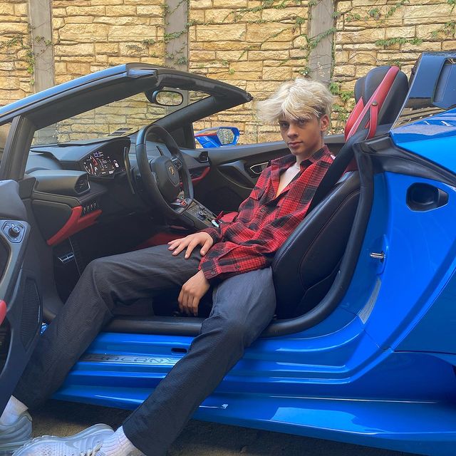 Picture of Chris Daniels posing for a photoshoot wearing red check shirt