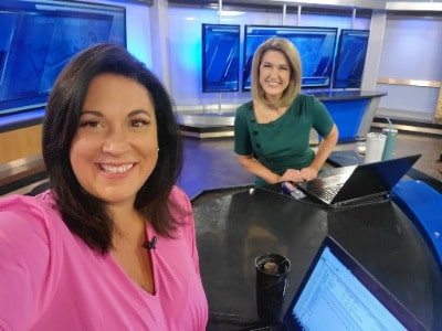 Alyson Acklin in KAKE TV with her colleagues in a green suit