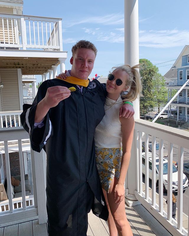 Photo of Miranda McKeon with her elder brother,  Sam McKeon, celebrating Sam's first adult job in NYC wearing white t-shirt