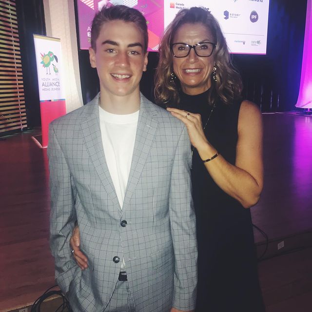 Picture of Isaac Kragten with his mother Bonnie Kragten posing for a photoshoot wearing grey color blazer