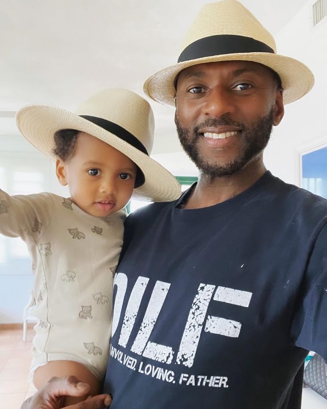 Romany Malco posing for a photo shoot with his son.