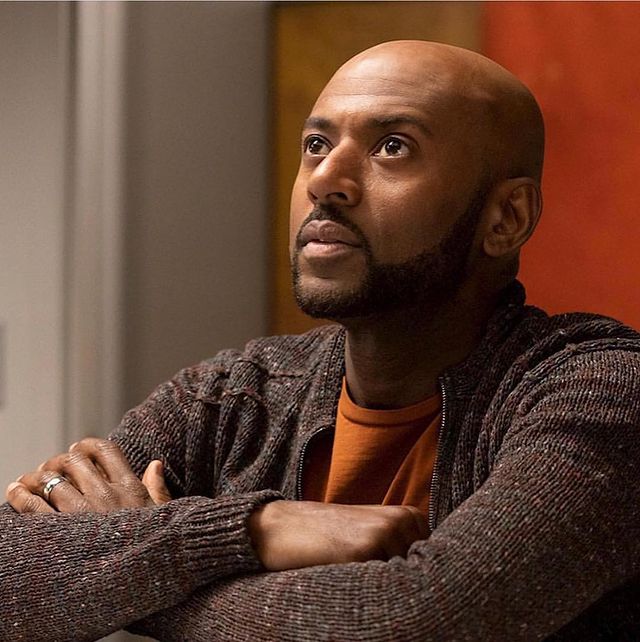 Romany Malco posing for his Instagram feed by wearing orange vest.