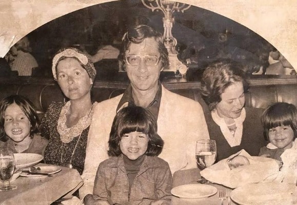 Elliot Beitner posing for a photo shoot by wearing a white suit.
