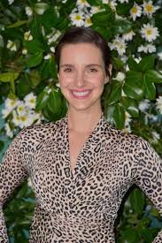 Carla Baratta wearing body cone and posing for the photo in a smiley face.