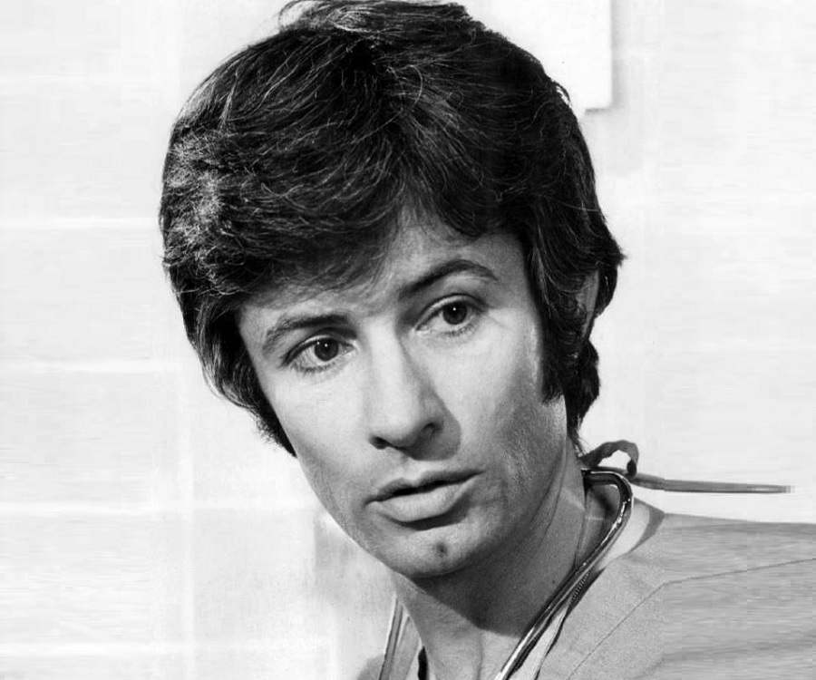 George Chakiris in his young age posing for the picture looking in a side 