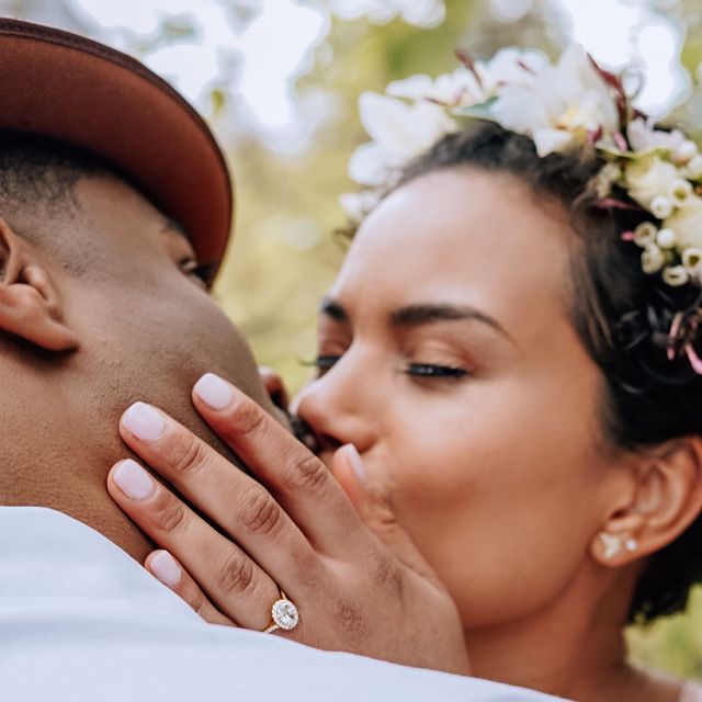 Picture of Michele Weaver kissing her husband wearing diamond ring on her fingure