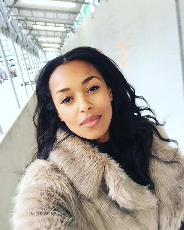 Picture of Melanie Liburd posing for a photoshoot wearing woolen jacket 