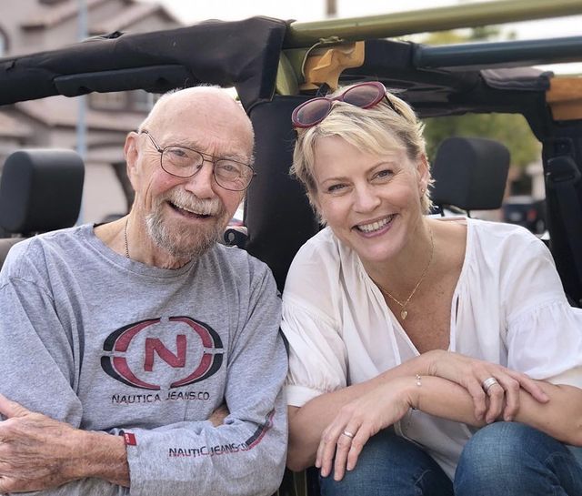 Picture of Marguerite MacIntyre with her father wearing white shirt and jeans pant