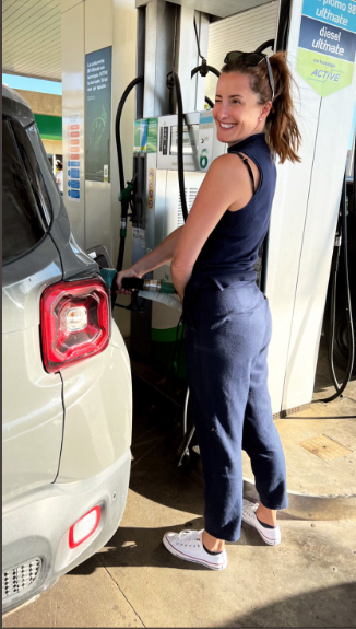 Picture of Rosanna Lockwood feuling her car 