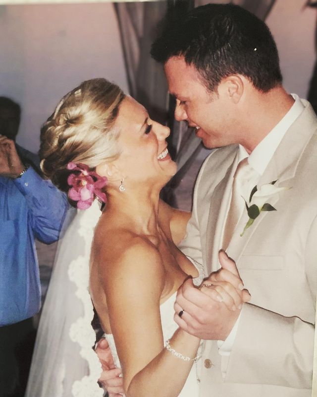 Amber Theoharis and Todd Buchler wearing white dress during their wedding 