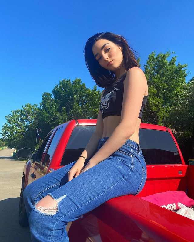 Indiana Massara posing for a photo shoot for her Instagram feed. 