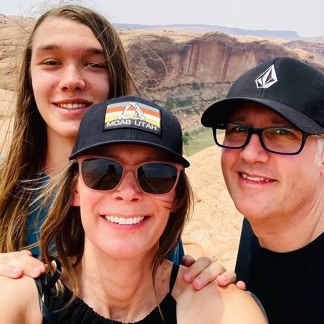 Kim Holden posing for her Instagram feed with her husband and son.