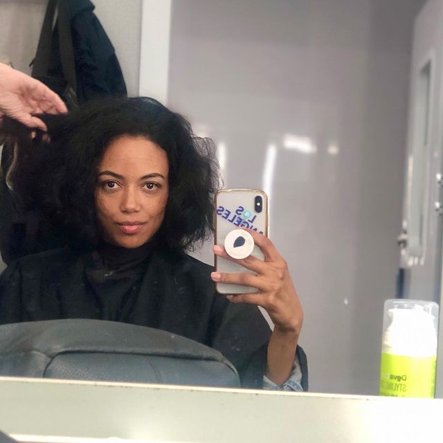 Picture of Shailene Garnett posing for a photoshoot with her phone