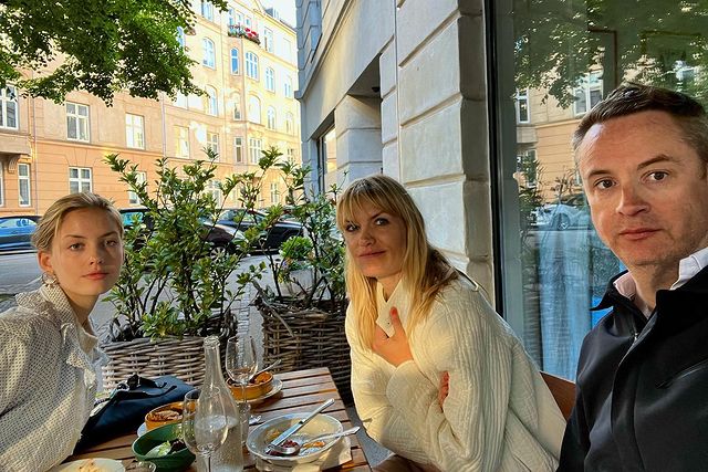 Picture of Liv Corfixen with her husband Nicolas Winding Refn and daughter Lola Winding Refn posing for a photoshoot wearing white color sweater