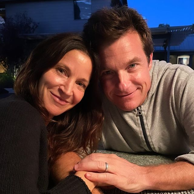 Picture of Maple Sylvie Bateman's parents posing for a photoshoot amanda wearing black color dress and Jason wearing grey color t shirt