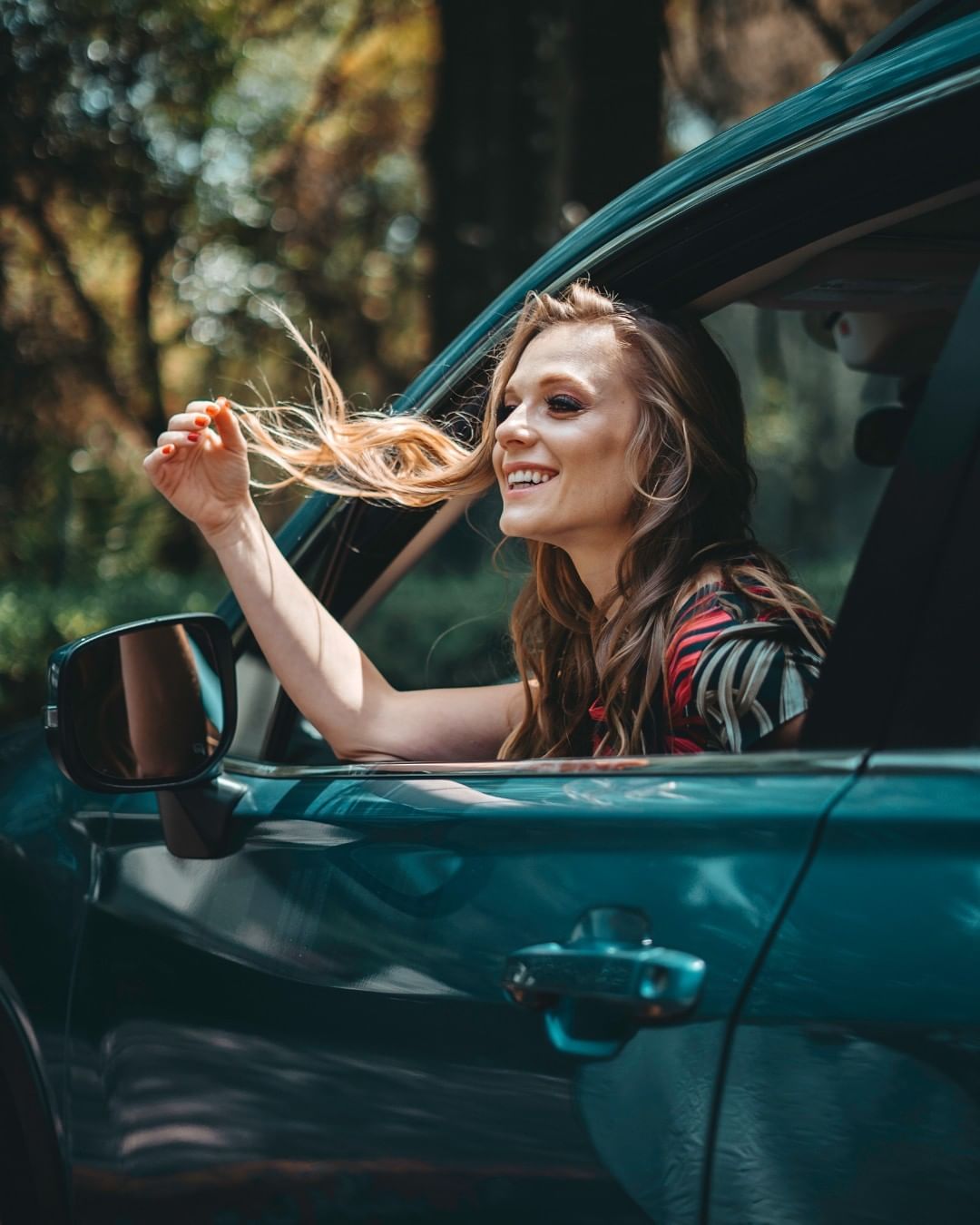  Ana Layevska posing for a photo shoot in her Subaru Forrester. 