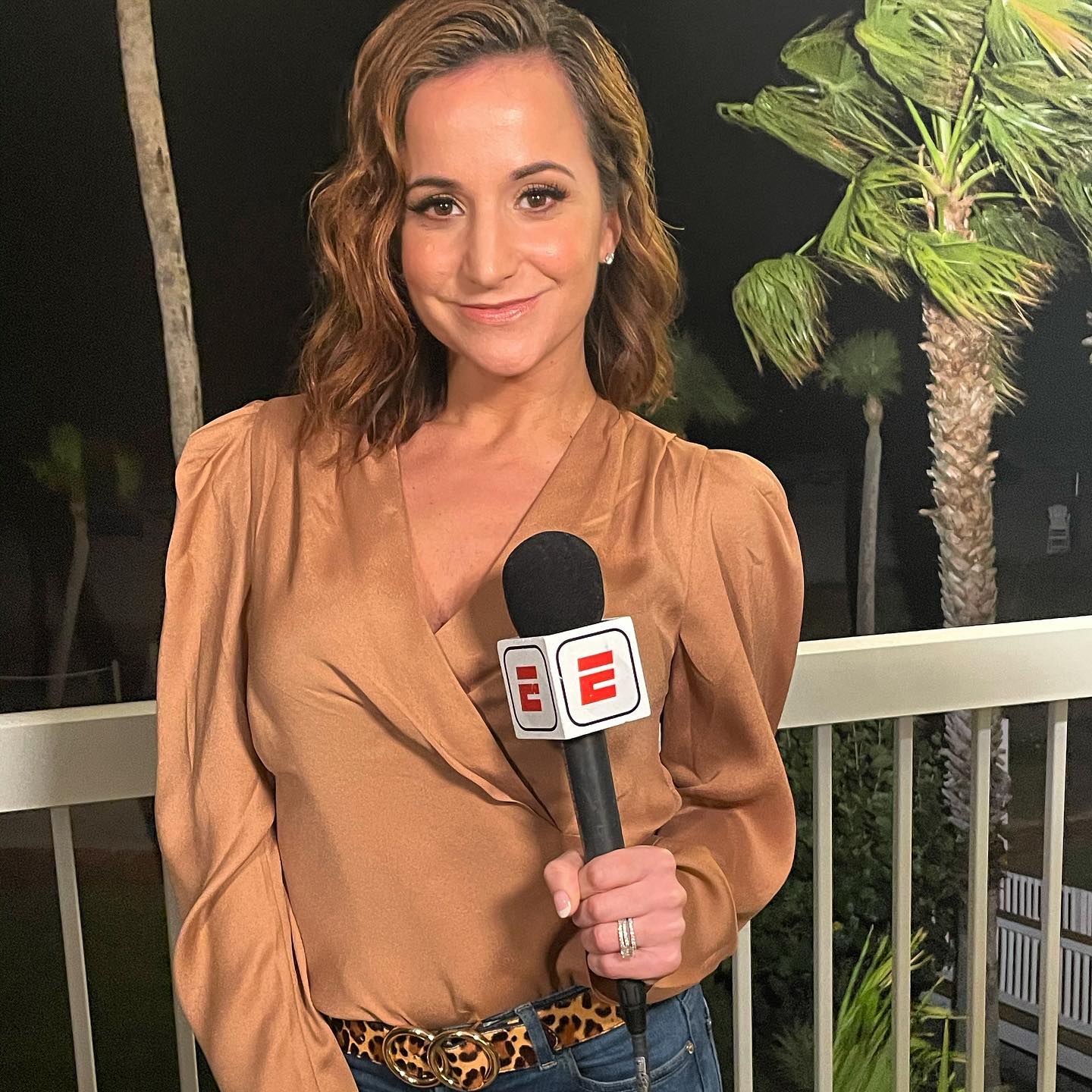 Picture of Dianna Russini holding microphone