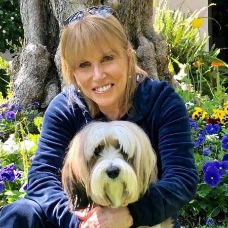 Leslie Charleson cuddling her Tibetan Terrier pet dog Riley Rose 