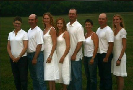 Picture of Jean Muggli (third from the left), her father and mother(left side) and her five siblings