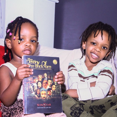 Teyhani and Seraphim Peterson with their father Sonstar Peterson's book.